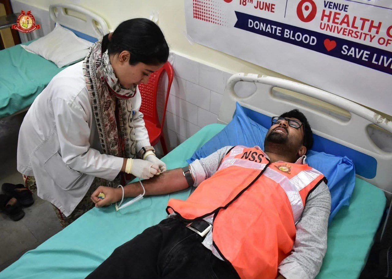 A blood donation in progress at a community camp