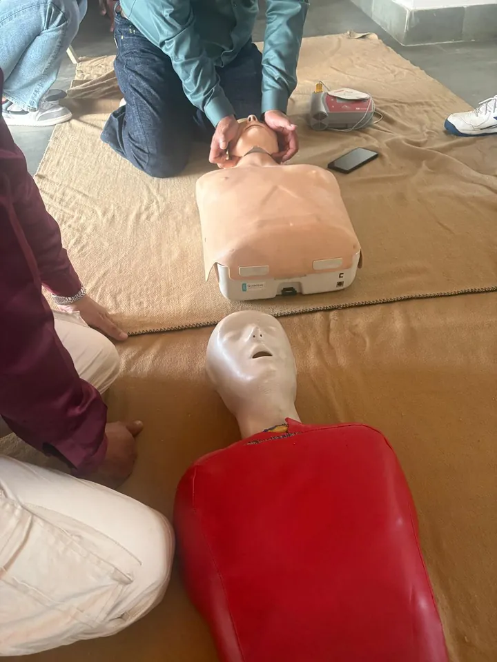 A participant practising chest compressions on a training mannequin