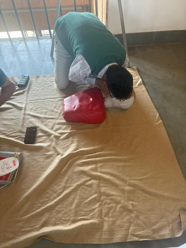 A participant practising rescue breathing on a CPR training mannequin