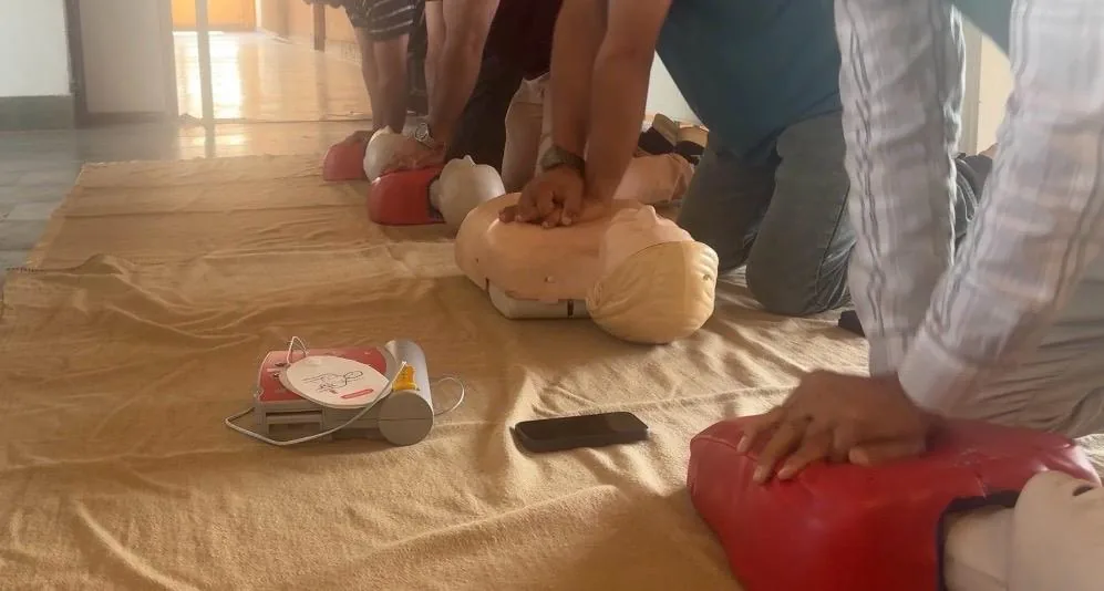 Participants practising chest compressions on CPR training mannequins