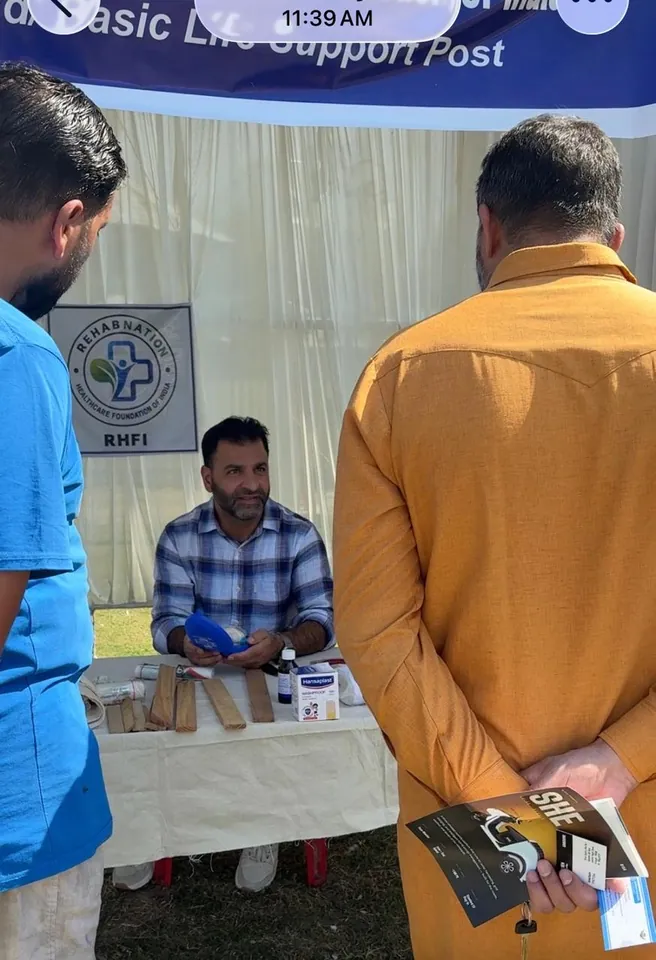Visitors speaking with a RehabNation team member at the EMERGE first-aid post at SKICC