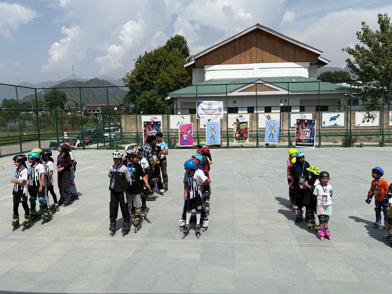 Children lined up at a skating ground in Kashmir